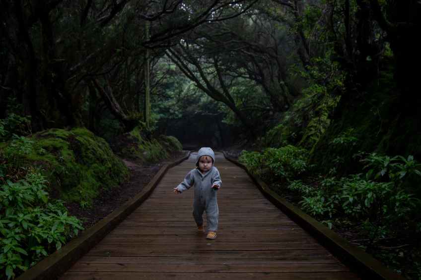 focused toddler running on middle of footpath a new experience