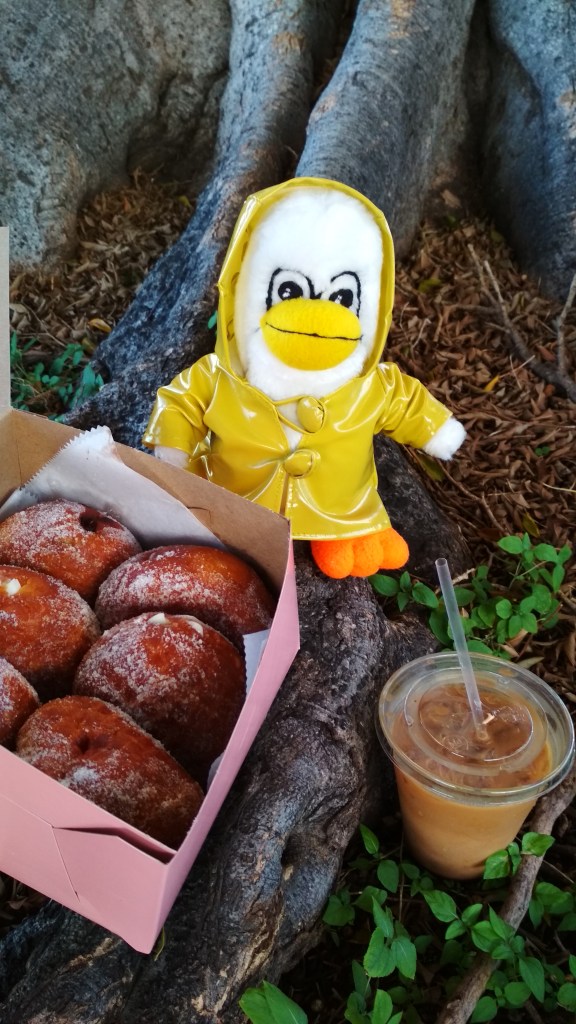 Penny Penguin and malasadas from Leonard's Bakery