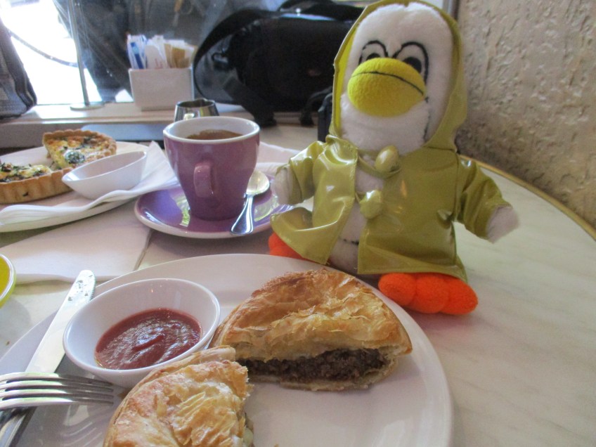 Penny Penguin at Stark's Cafe with a mince and cheese pie