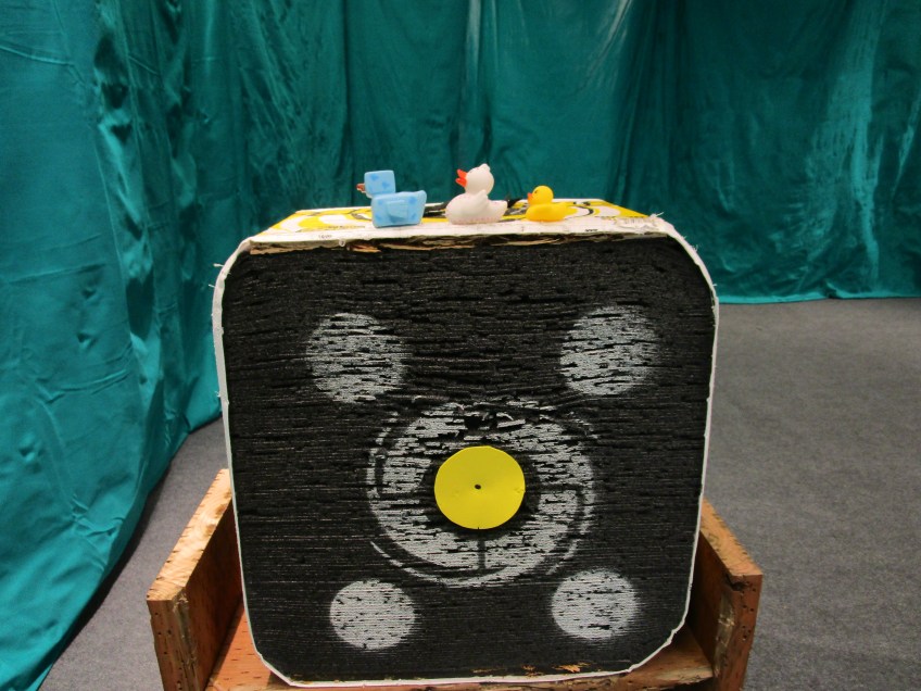 Three rubber ducks sitting on a target