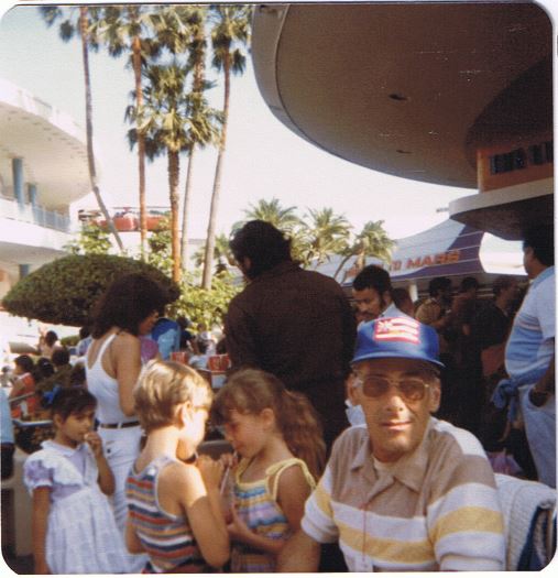 Grandpa Bob in Tomorrowland; my sister and I share a drink in the background, 1982