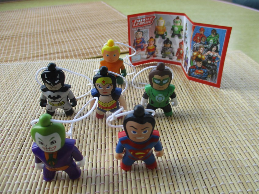 An incomplete collection of Justice League Kinder Egg toys